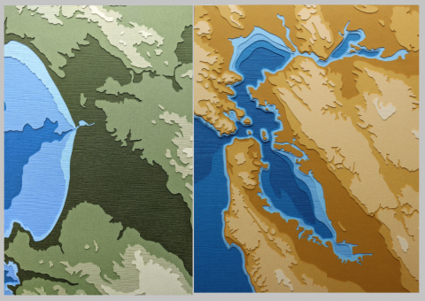 photo of Monterey Bay and San Francisco Bay papercut artworks side by side