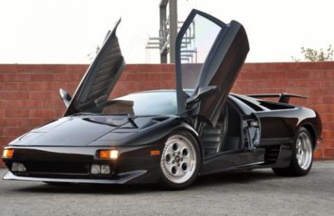 photo of a black, 1992 Lamborghini Diablo with the doors open