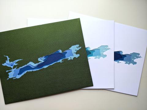 photo of three "Gunflint & Magnetic Lakes" cut paper artworks