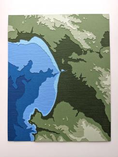 photo of layered papercut artwork depicting Monterey Bay, California