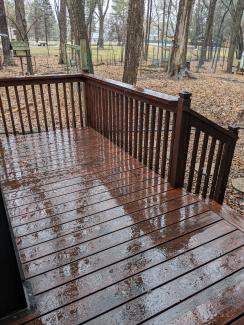 photo of deck and back yard, wet with snowmelt and rain